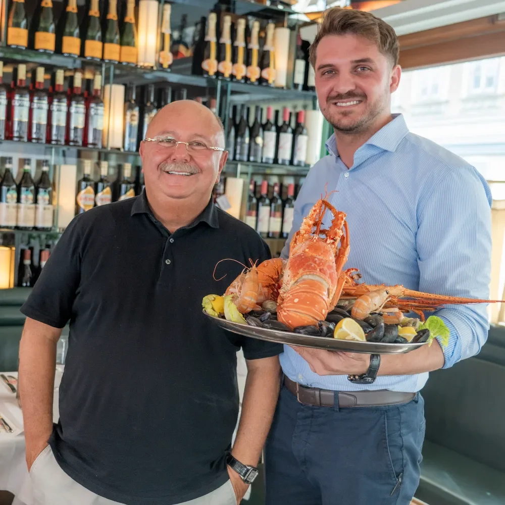 Owner Sabu Topallar and restaurateur Sorin Spiridon with a seafood platter at Nautilus